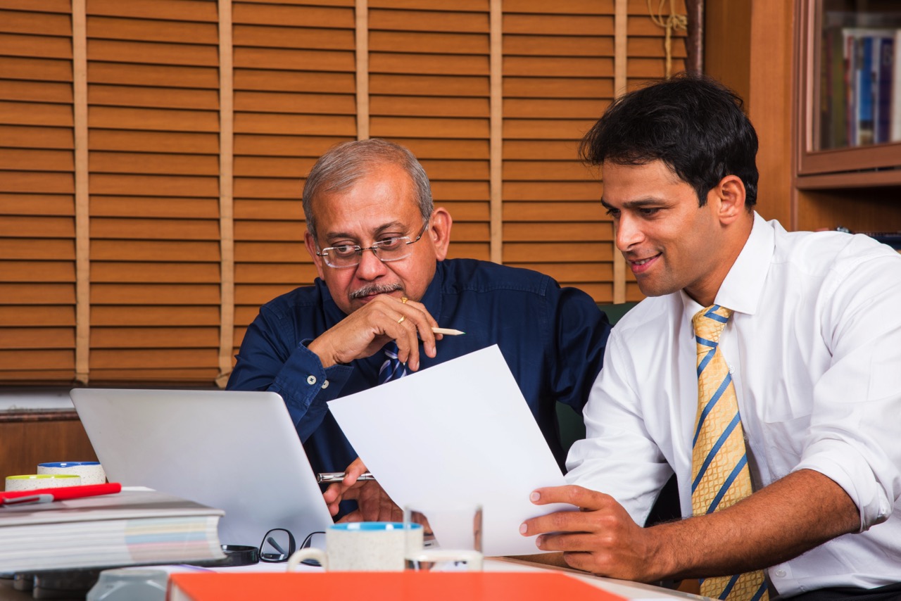 Asian Indian Business People or Corporate culture and Working in the office Concept with Laptop, papers, meetings, presentations and discussions