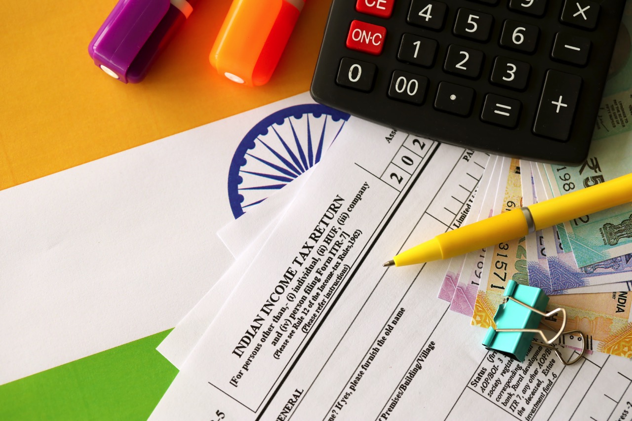KYIV, UKRAINE - MAY 4, 2022 Indian income tax return blank form with pen and indian rupees bills