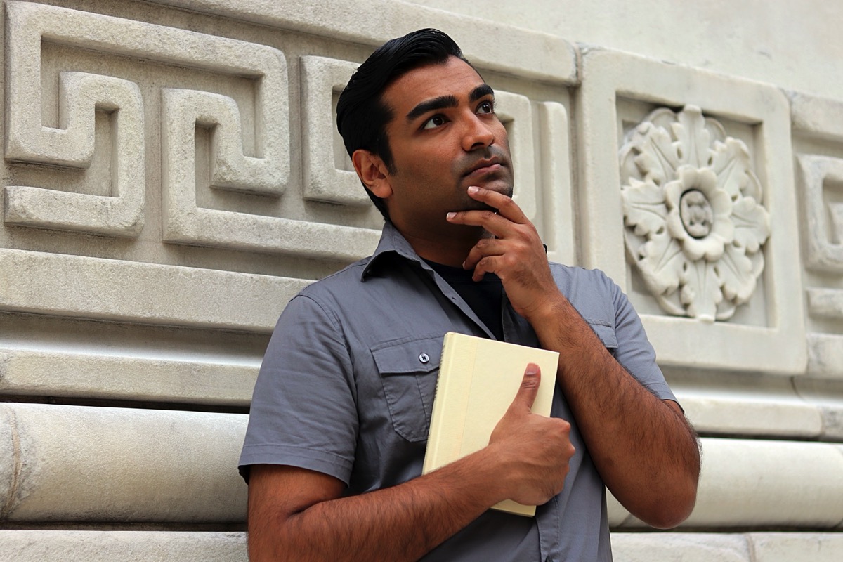 man-looking-away-while-standing-against-wall